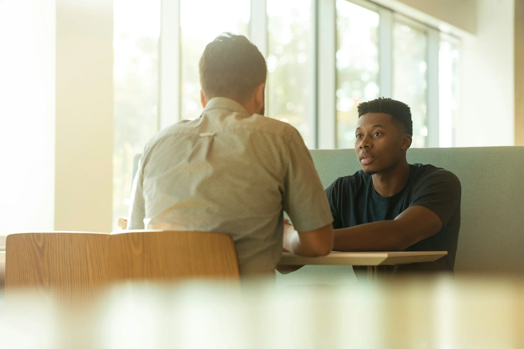 Colleagues talking across a table