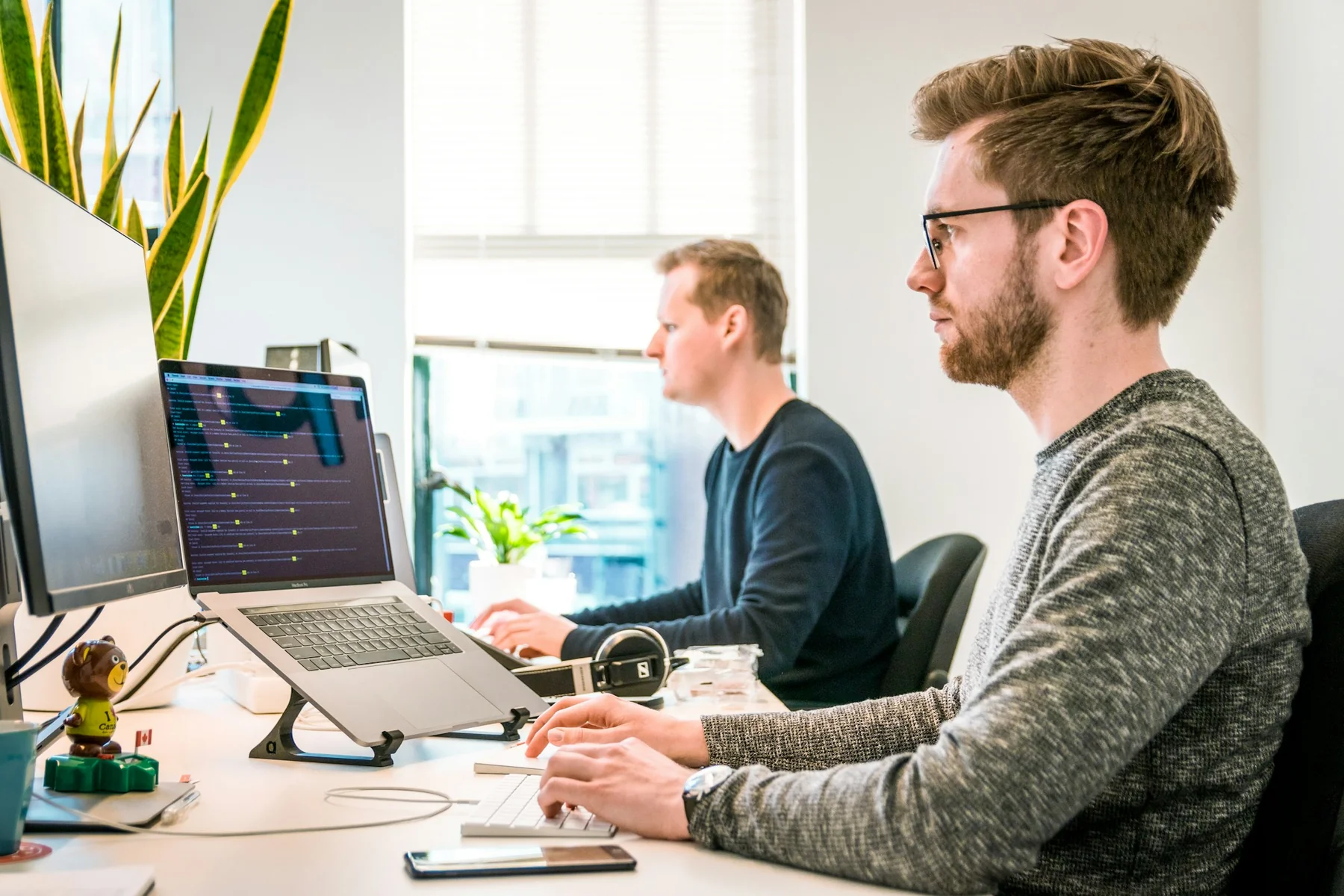 Colleagues concentrating at desks in a bright office